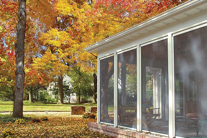 Exterior sunroom shown in fall with retractable screens lowered